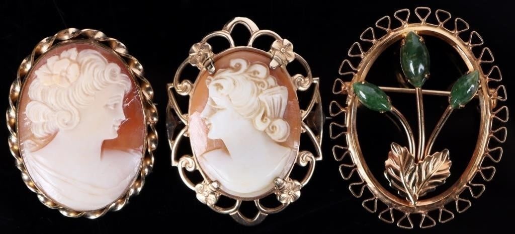 12K GOLD FILLED LADIES BROOCHES LOT OF 3: 12K gold filled ladies brooches lot of 3. In this lot there are two beautifully carved cameo brooches and one flower brooch with cabochon nephrite stones.Weight: 15.49 Grams totalCondition: Very well
