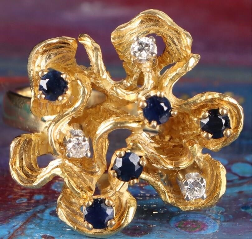 18K YELLOW GOLD SAPPHIRE DIAMOND LADIES CORAL RING: 18K yellow gold sapphire diamond ladies cast coral ring. Gemstones to include five 0.07ct round cut sapphire and three 0.03ct round cut diamonds.Stone Type: AssortedWeight: 11.89 GramsSize: 9.00 U.S.C