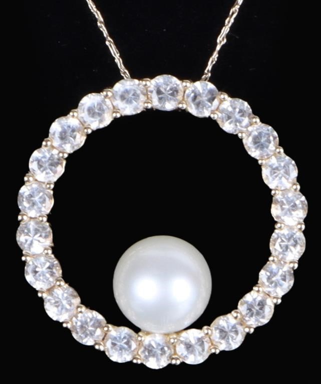 10K YELLOW GOLD LADIES NECKLACE W/ PEARL PENDANT: 10k yellow gold ladies necklace with a circular pendant ringed with diamond simulants and with a genuine round white 7.15mm diameter pearl set at its bottom.Stone Type: PearlWeight: 3.43 gramsSize: 21