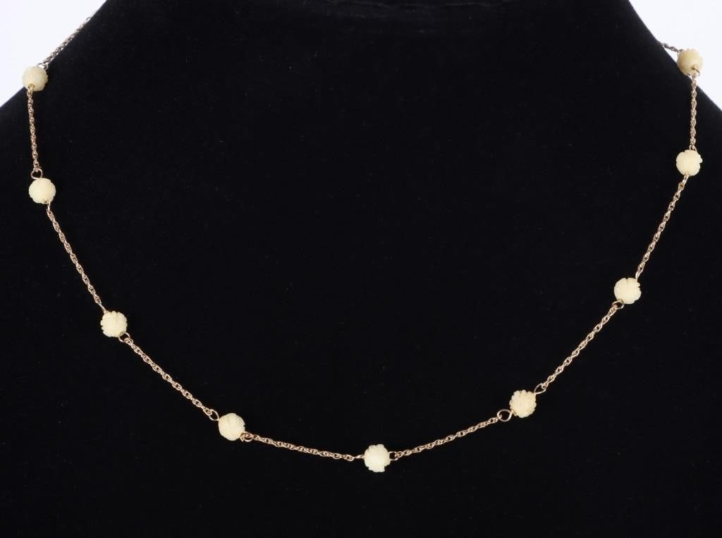 14K YELLOW GOLD LADIES NECKLACE W/ BONE ROSETTES: 14k yellow gold ladies chain necklace with twelve finely-carved bone rosette beads spaced evenly across its length.Stone Type: BoneWeight: 2.5 gramsSize: 16" longCondition: See pictures.