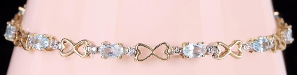 10K YELLOW GOLD TOPAZ HEART INFINITY BRACELET: 10K yellow gold topaz heart infinity ladies tennis bracelet. Gemstones to include ten 0.20ct oval cut blue topaz.Stone Type: TopazWeight: 4.23 GramsSize: 7.25"Condition: Little to no wear, see images