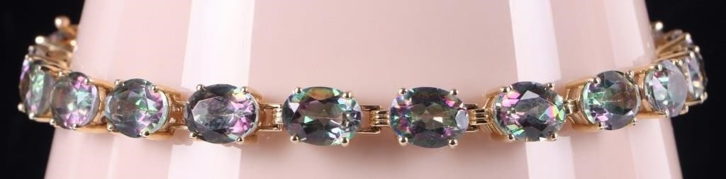 10K YELLOW GOLD LADIES BRACELET W/ TOURMALINE GEMS: 10k yellow gold ladies bracelet with twenty glittering medium-sized oval-cut tourmaline gemstones along its edge. Signed 'JH'.Stone Type: TourmalineWeight: 15.41 gramsSize: 8.5" longCondition: See pic