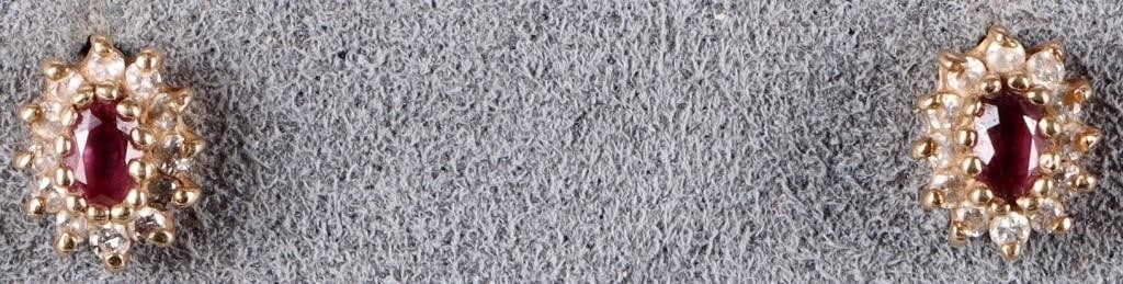 14K YELLOW GOLD LADIES EARRINGS W/ RUBY & DIAMONDS: Pair of 14k yellow gold ladies earrings, each of which feature one 0.025ct oval-cut ruby gemstone and twelve melee diamonds.Stone Type: DiamondWeight: 1.26 gramsSize: 7.5 X 6 mmCondition: See pictures