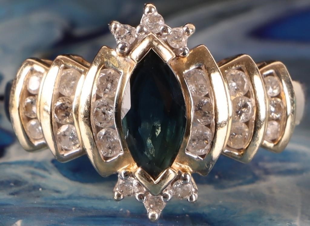 14K YELLOW GOLD LADIES RING W DIAMONDS & SAPPHIRE: 14k yellow gold ladies ring with a 0.5ct marquise-cut blue sapphire center gemstone surrounded by twenty-four round-cut diamonds (twelve 0.01ct, six 0.02ct, and six 0.03ct - 0.36ctw). Two sections of 
