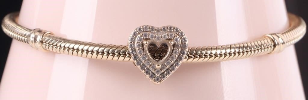 PANDORA 14K YELLOW GOLD SNAKE CHAIN CZ BRACELET: Pandora 14K yellow gold snake chain heart clasp CZ ladies bracelet. Stone Type: CZ Weight: 25.54 Grams Size: 7.50" Condition: One heart cut CZ missing. See images for details.