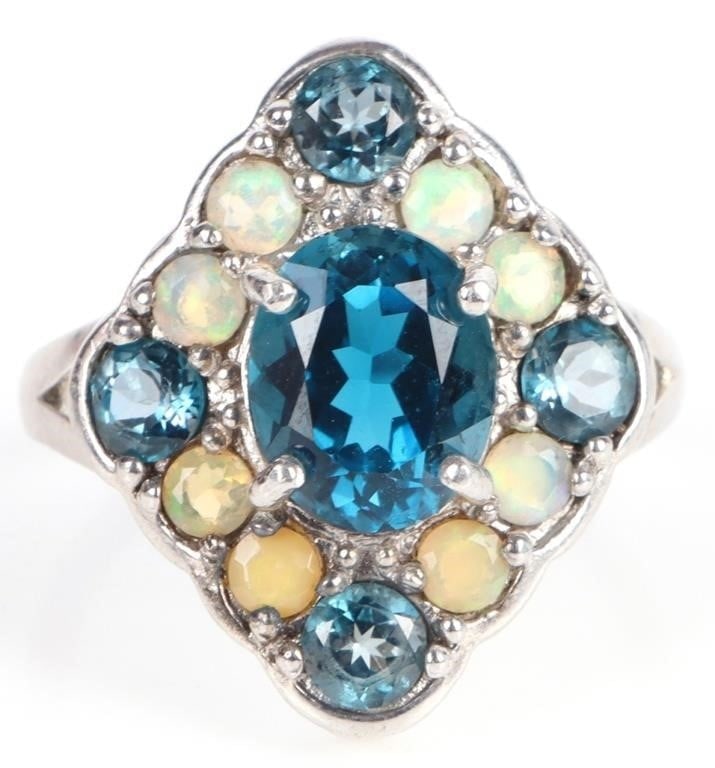 BLUE TOPAZ & YELLOW OPAL STERLING SILVER RING: Blue topaz and yellow opal sterling silver ladies ring. Stone Type: Assorted Weight: 5.45 Grams Size: US 9 Condition: See pictures.
