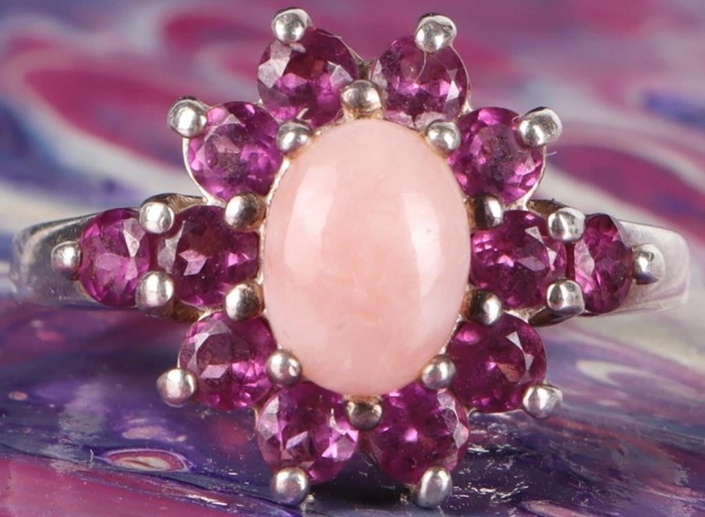 STERLING SILVER PINK TOURMALINE CHALCEDONY RING: Sterling silver pink tourmaline chalcedony ladies ring. Gemstones to include one 8.23mm X 6.19mm oval cabochon pink chalcedony, and twelve 0.07ct round cut pink tourmaline. Stone Type: Assorted Weight