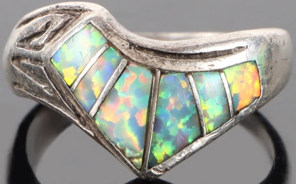 STERLING SILVER CARVED OPAL LADIES RING: Sterling silver carved opal ladies ring to include six cabochon opal. Stone Type: Opal Weight: 4.00 Grams Size: 6.25 U.S. Condition: Some wear, see images for details.