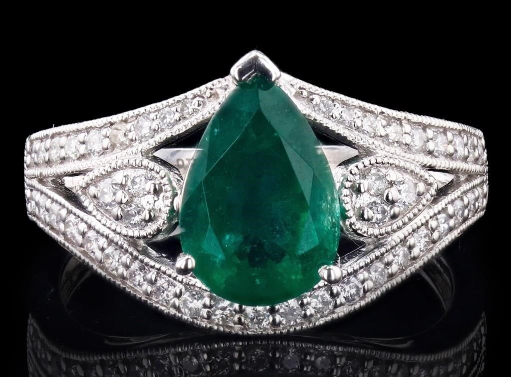 2.27CT EMERALD PLATINUM LADIES RING W/ DIAMONDS: One electronically tested platinum ladies cast and assembled emerald & diamond ring. Condition is new, good workmanship. The featured emerald is set within diamond ribbons and between mirroring diamon