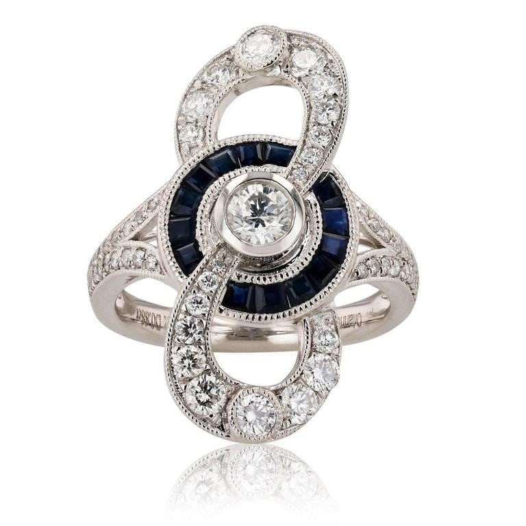 1.17CTW DIAMONDS PLATINUM LADIES RING W/ SAPPHIRE: One electronically tested platinum ladies cast & assembled diamond & sapphire ring. Condition is new, good workmanship. The featured diamond is set within a sapphire bezel interconnected to a diamond 