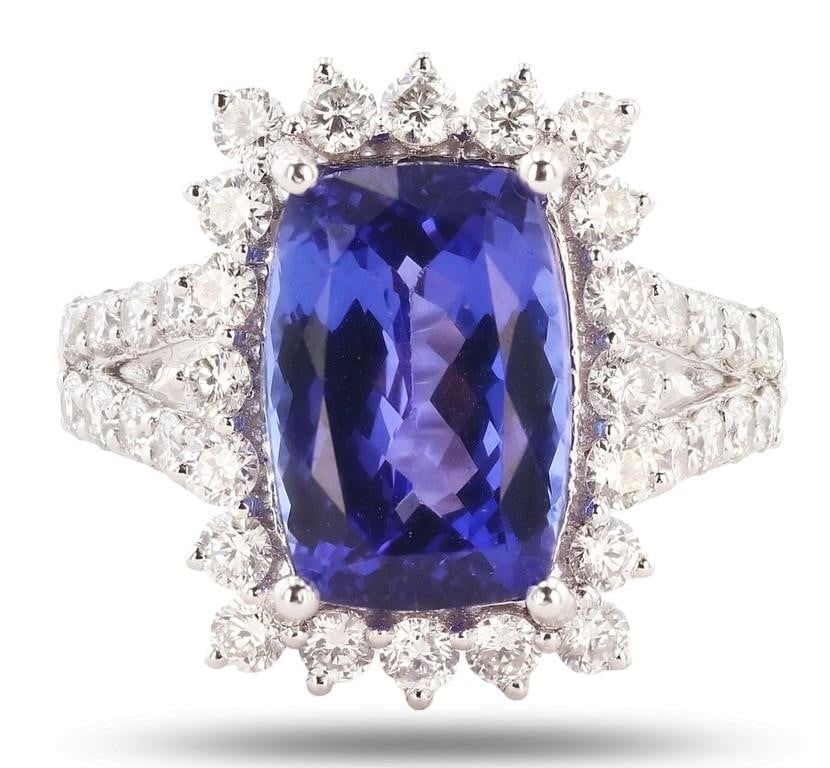 1.45CTW DIAMOND 6.71CTW TANZANITE PLATINUM RING: One electronically tested platinum ladies cast tanzanite and diamond ring with a bright polish finish. Condition is new, good workmanship. The featured tanzanite is set within a diamond floret bezel s