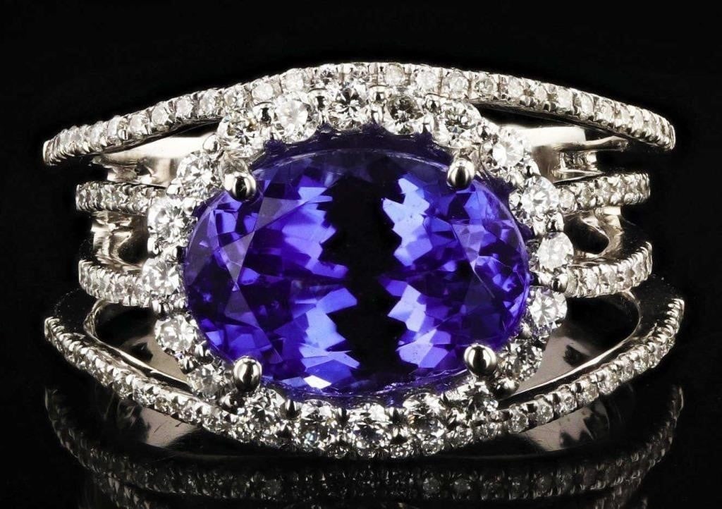 4.26CT TANZANITE PLATINUM LADIES RING W/ DIAMONDS: One electronically tested platinum ladies cast & assembled tanzanite & diamond ring. Condition is new, good workmanship. The featured tanzanite is set within a diamond bezel, supported by a series of 
