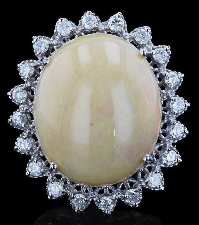 22.17CT OPAL 1.16CTW DIAMOND 14K WHITE GOLD RING: One electronically tested 14KT white gold ladies cast & assembled white opal and diamond ring with a bright polish finish. Featuring a white opal set within a diamond frame, supported by tapering shou