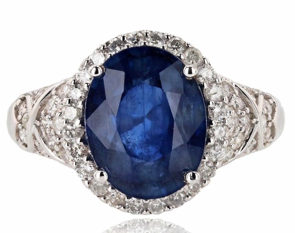 14K WHITE GOLD LADIES RING W/ DIAMONDS & SAPPHIRE: One electronically tested 14KT white gold ladies cast sapphire and diamond ring with a bright polish finish. Condition is new, good workmanship. The featured sapphire is set within a diamond bezel sup