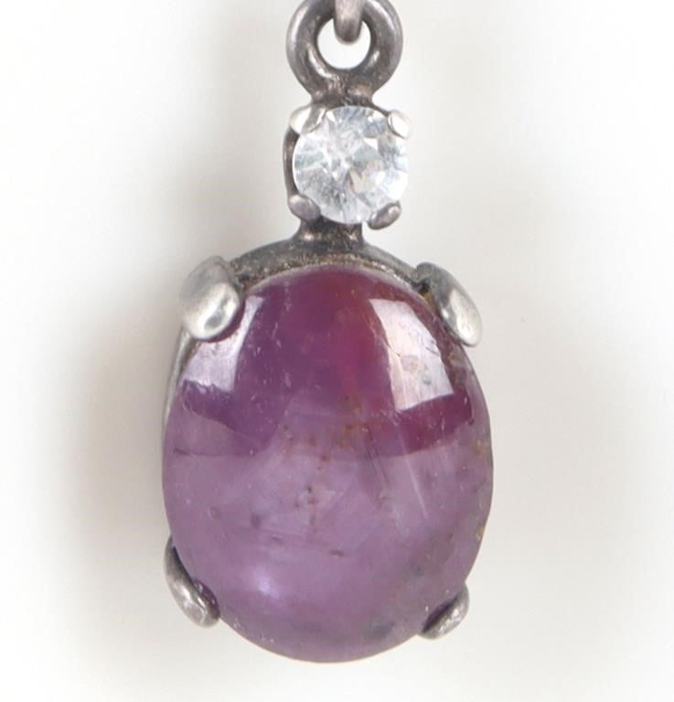 1.5CT STAR RUBY & SAPPHIRE STERLING NECKLACE: 1.5CT cabochon star ruby and one 0.03CT round white sapphire sterling silver ladies necklace. Stone Type: Ruby Weight: 4.34 Grams Size: 18" Length Condition: Gently used. See images for complete condi