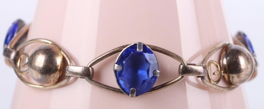 1/20 12K GOLD FILLED BLUE GEM LADIES BRACELET: 1/20th 12K gold filled blue gem ladies bracelet. Bracelet contains 5% of the weight 12K gold. Design features an interesting coiled bead alternated with the blue gemstone. Stone Type: Assorted Weight: