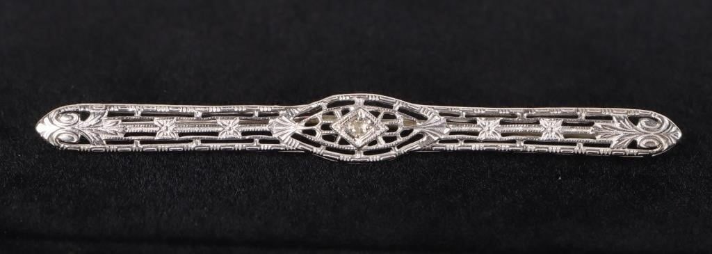 ANTIQUE ART DECO 14K WHITE GOLD SAPPHIRE BROOCH: Antique Art Deco 14k white gold sapphire ladies brooch with one 0.02ct round sapphire. Stone Type: Sapphire Weight: 3.21 Grams Size: 2.5" length Condition: Very fine.