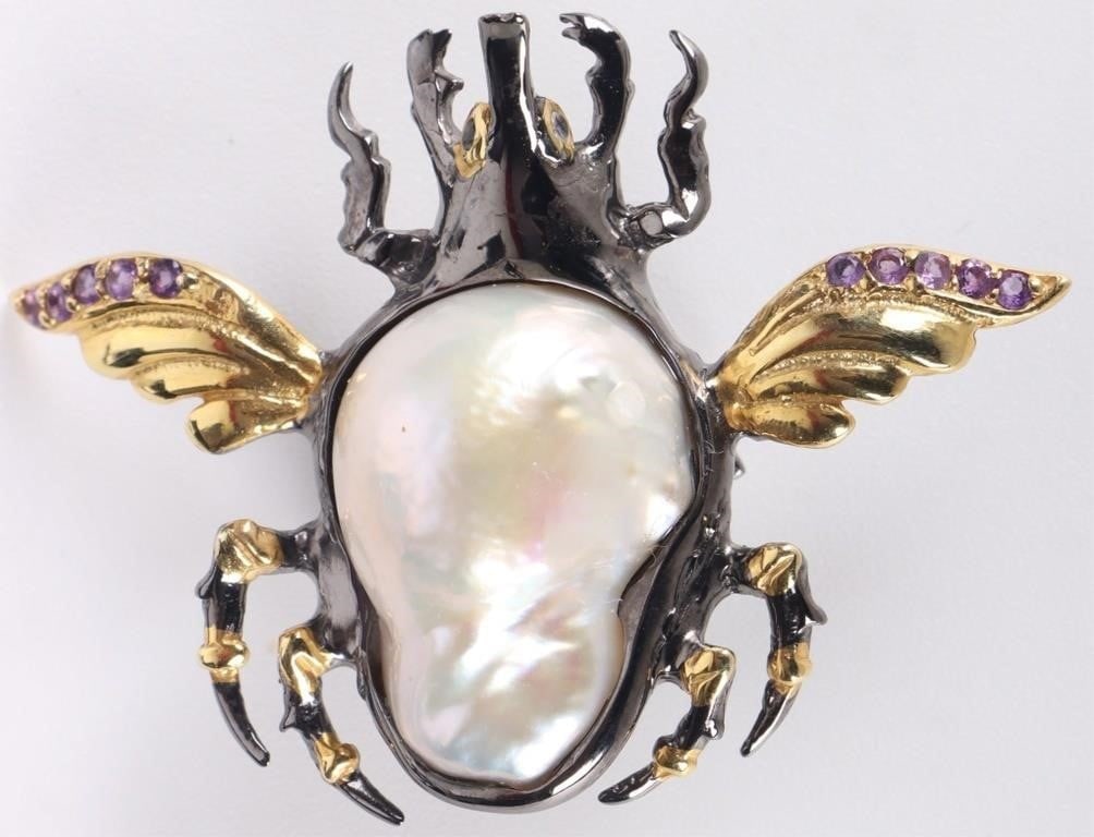 STERLING SILVER BROOCH WINGED SCARAB W/ PEARL: Sterling silver ladies brooch of a winged scarab. The abdomen features a large 21.9mm baroque pearl, the wings feature amethyst gemstones, and the eyes are topaz. Excellent piece for those with a tast