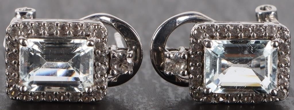 1.5CTW AQUAMARINE & TOPAZ LADIES STERLING EARRINGS: 1.5CTW aquamarine and white topaz ladies sterling silver earrings. The center stone is a 0.75CT emerald cut aquamarine surrounded by 20 0.01CT white topaz. Each earring has one 0.05Ct white topaz at t