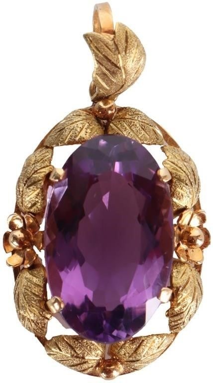 ~10CT AMETHYST 18K YELLOW GOLD LADIES PENDANT: 18k yellow gold ladies pendant with a 10ct oval-cut amethyst center gemstone. The rim features textured leaves about its circumference aside from two rosettes directly beside the amethyst. Stone Type: