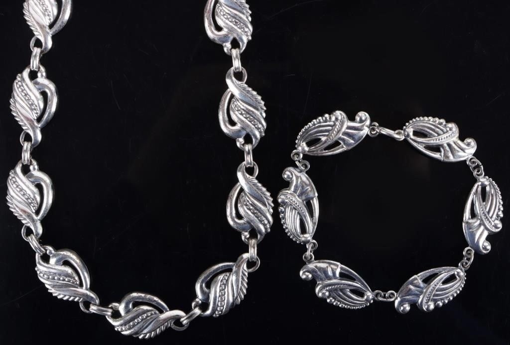STERLING SILVER LADIES BRACELET & NECKLACE SET: Sterling silver ladies bracelet and necklace set. Each piece features repeated abstract flourishes as brackets. Both are signed by Danecraft. Weight: 36.49 grams Condition: See pictures.