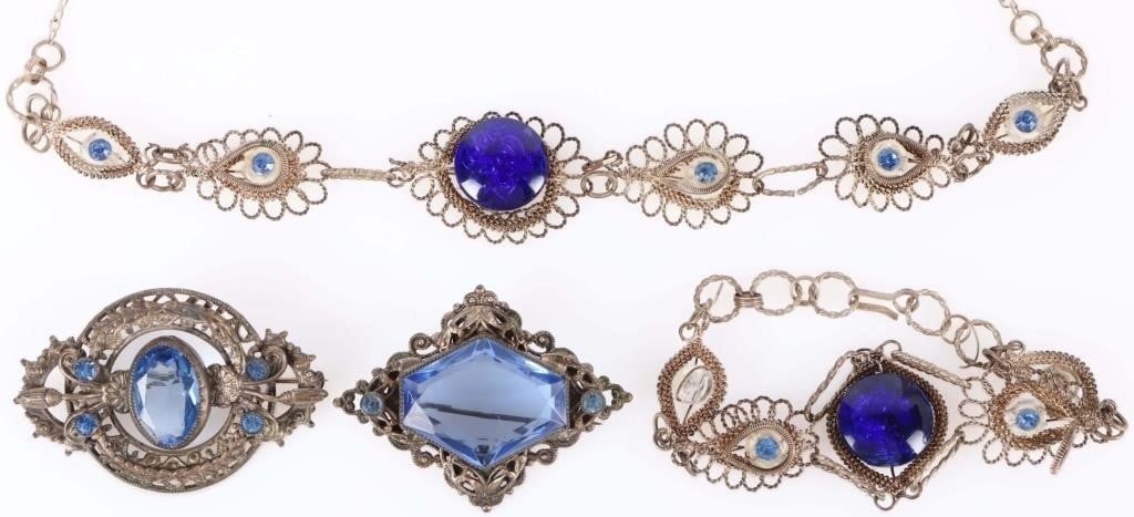 VINTAGE FILIGREE SILVER-TONED BLUE GLASS JEWELRY: Vintage filigree silver-toned blue glass ladies jewelry to include: two antique brooches and one matching set of bracelet and necklace. Stone Type: CZ Size: 20" largest Condition: Wear commensurate wi