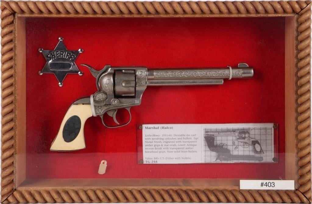 LESLIE-HENRY MARSHAL (HALCO) 1955 DIE CAST CAP GUN: Leslie-Henry Marshal (Halco) 1955. To feature desirable die cast with revolving cylinders. Nickel finish, engraved with solid white grips and star ovals. Size: 15 X 10 X 3" framed. Condition: Very fin
