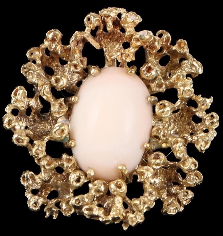 18K YELLOW GOLD CREAM CORAL ORNATE LADIES RING: 18K yellow gold cream coral ornate ladies ring. Gemstones to include one 13.80mm X 9.38mm cabochon cream coral. Stone Type: Coral Weight: 10.51 Grams Size: 5.50 U.S. Condition: Little to no wear, see 