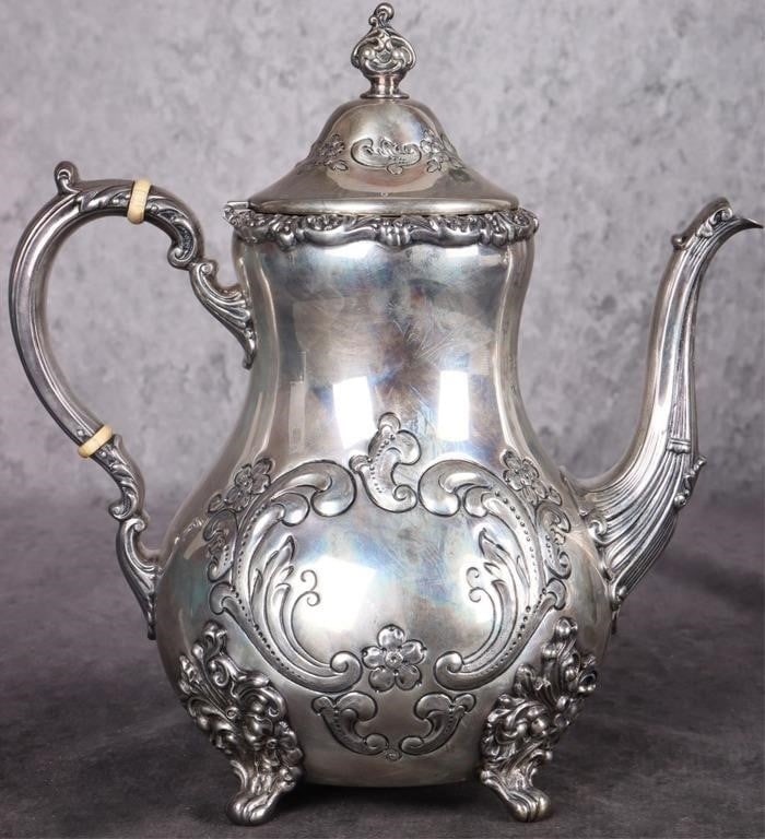 POOLE STERLING SILVER OLD ENGLISH TEA POT: Poole sterling silver Old English teapot. It has an ornate scroll design and three ornate feet with a hinged lid. The hallmark reads Old English Hand Chased Sterling By Poole 700 and shows the Lion fi