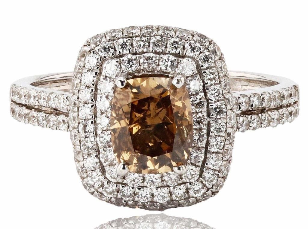 1.18CT FANCY BROWN DIAMOND18K GOLD RING 2.11CTW: One electronically tested 18KT white gold ladies cast diamond ring with a bright polish finish. Condition is new, good workmanship. The featured diamond is set within tiered diamond bezels supported b