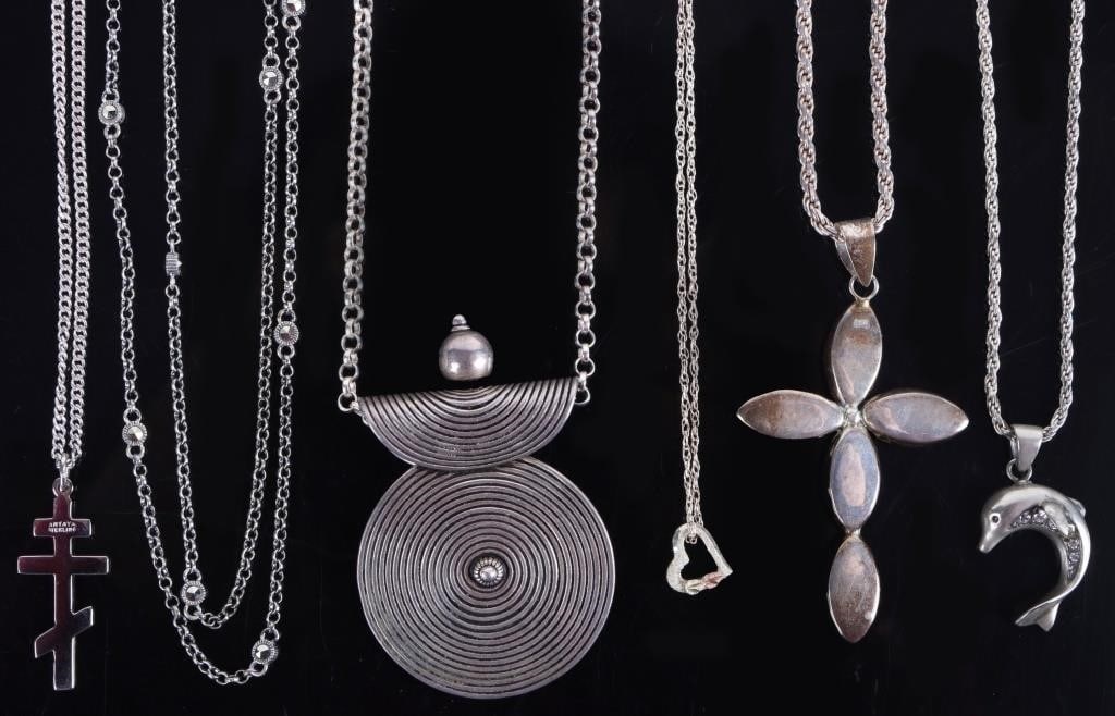STERLING SILVER NECKLACES CROSSES COLORED STONE-6: Sterling silver ladies necklaces. This lot includes a necklace with a disc filled with concentric circles, a necklace with a cross with red stones, a necklace with an Eastern Orthodox cross, a necklac