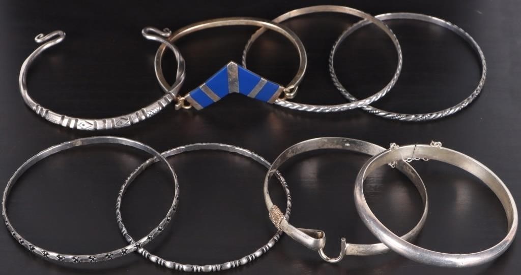 STERLING SILVER LADIES BRACELETS LOT OF EIGHT: Lot of eight pieces of sterling silver ladies bracelets, of note are a piece with blue jasper on its face and a piece with gold-tone ropework wrapped near the clasp. Weight: 90.6 grams Condition: See 