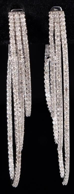 DOZENS OF DIAMONDS 14K WHITE GOLD LADIES EARRINGS: 14k white gold ladies three-looped earrings, with each elliptical loop extending progressively lower. All loops are studded with dozens of melee diamonds. Stone Type: Diamond Weight: 5.85 grams Size: 