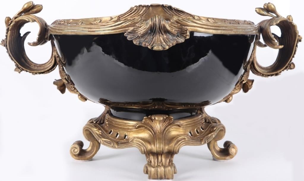 CASTILIAN IMPORTS EMPIRE STYLE CENTERPIECE BOWL: Castilian Imports French Empire style centerpiece bowl composed of black porcelain and cast ormolu brass. Circa 1980's. 31.3 lbs. Size: 22 x 15 x 12" Condition: Corrosion on brass, see pictures for mo