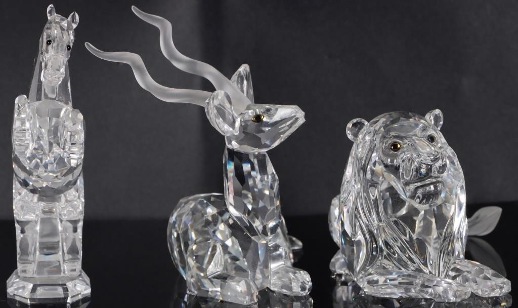 SWAROVSKI LION KUDU & WHITE STALLION LOT FIGURINES: Lot of three Swarovski crystal figurines, to include the1995 lion from the Inspiration Africa series (5 x 3.5 x 3"), the 1994 kudu from the Inspiration Africa series (4 x 4 x 3.75"), and the 2005 Whit