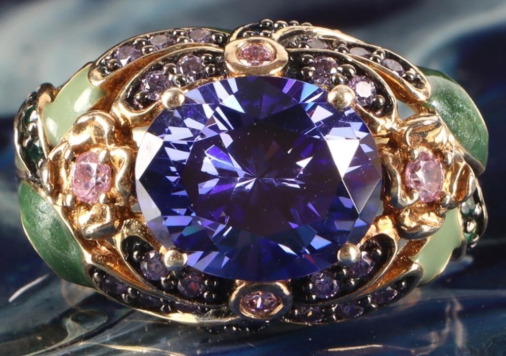 STERLING SILVER TOPAZ LADIES ENAMEL RING: Gold-tone sterling silver ladies ring. The piece is covered in stones, with the blue pieces on the end being 0.02ct topaz gemstones (seven on each side). Stone Type: Topaz Weight: 8.91 grams Size: US 