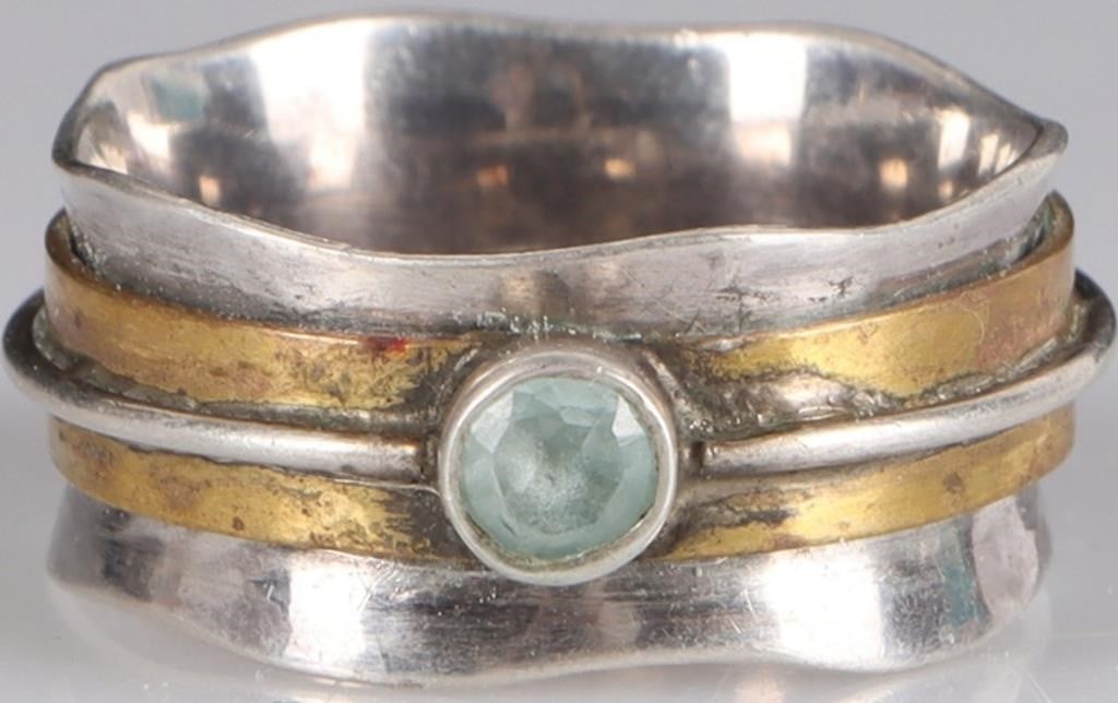 STERLING SILVER LADIES RING W/ TOPAZ CENTER STONE: Sterling silver ladies ring with a 0.25ct round-cut topaz center gemstone. The band is composed of three elements: a thick inner band, a thinner gold-on-silver band, and a thin silver band wrapped aro