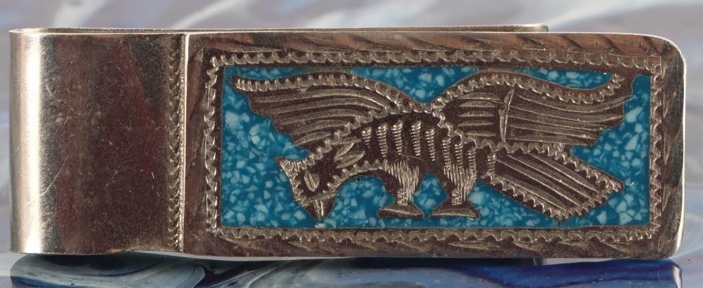 STERLING TURQUOISE NATIVE AMERICAN MONEY CLIP: Sterling silver turquoise Native American money clip. This money clip features a sterling silver thunderbird surrounded by a turquoise inlay. Stone Type: Turquoise Weight: 16.25 Grams Size: 2 3/8" x 3