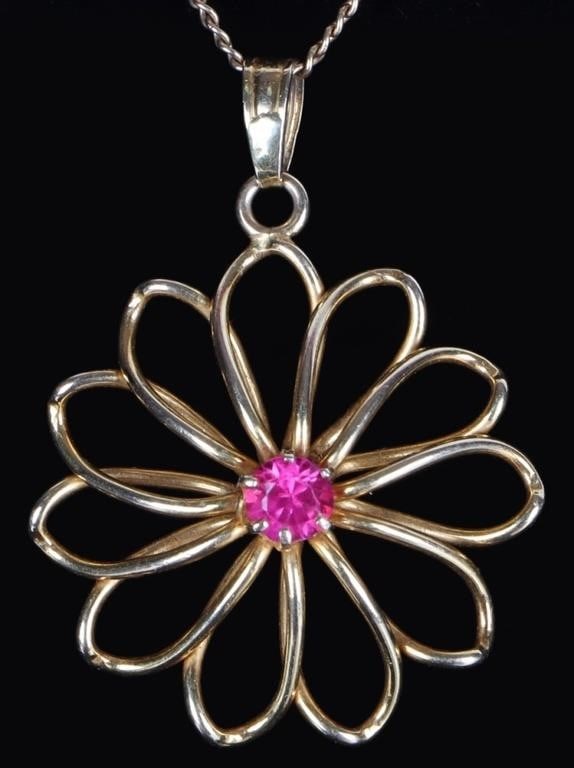 10K YELLOW GOLD FLORAL LADIES NECKLACE W/ RUBY: 10k yellow gold ladies necklace featuring a minimalist floral pendant with a 0.33ct round-cut ruby center gemstone. Stone Type: Ruby Weight: 4.42 grams Size: 18" long Condition: See pictures.