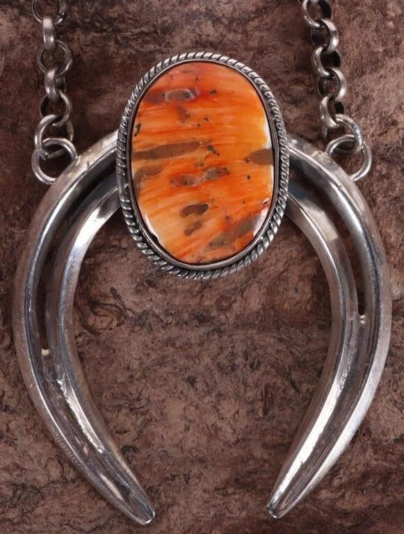 SW STYLE 925 HORSESHOE NECKLACE W/ SPINY OYSTER: Southwest style sterling silver ladies necklace with a horseshoe pendant and a polished oval-cut spiny-oyster stone set on top of the pendant. Stone Type: Spiny Oyster Weight: 45.11 grams Size: 20.5" 