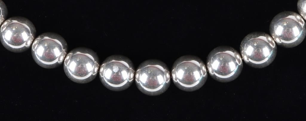 TIFFANY & CO STERLING BEADED BALL LADIES NECKLACE: Tiffany & Co. sterling silver ladies beaded ball necklace. All of the beads are the same size. Weight: 47.27 Grams Size: 18" Condition: Like new. See images for complete condition.