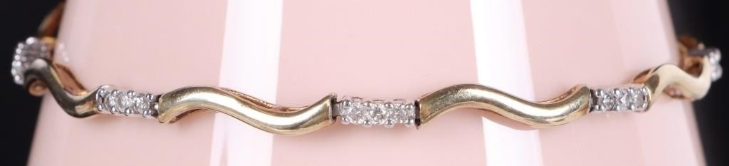 10K YELLOW/WHITE GOLD LADIES BRACELET W/ 24 DIAS: 10k yellow/white gold ladies bracelet with eight yellow gold curled links and eight white gold links with three 0.01ct round-cut diamonds on each, making for a 0.24ctw. Stone Type: Diamond Weight: 4.4