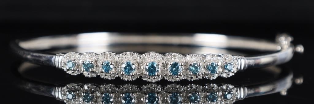 64 DIAMONDS ELEGANT 14K WHITE GOLD LADIES BRACELET: Elegant 14k white gold ladies bracelet with a face covered in nine blue diamonds stimulants and surrounded by sixty-four melee diamonds. Stone Type: Diamond Weight: 12.17 grams Size: 2.5 x 2.5" Condit