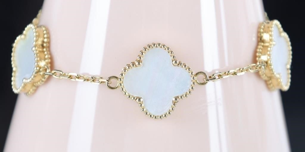 18K YELLOW GOLD MOTHER OF PEARL CLOVER BRACELET: 18K yellow gold Mother of Pearl clover ladies bracelet after the iconic clover design of Van Cleef & Arpels. Gemstones to include five 15.1mm clover mother of pearl. Lobster clasp. Stone Type: Mother 