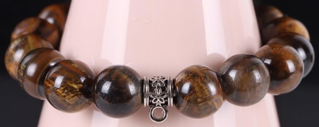 TIGER IRON BEAD UNISEX BRACELET: Tiger Iron bead unisex bracelet. This unique gem is a mixture of tiger's eye and hematite making it slightly magnetic. Stone Type: Tigers Eye Weight: 43.70 Grams Size: 9.50" Condition: Little to no we