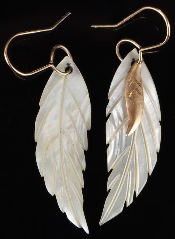 14K YELLOW GOLD MOTHER OF PEARL FEATHER EARRINGS: Pair of ladies earrings the hooks of which are 14k yellow gold and the main dangling elements are large pieces of mother of pearl which are carved in the shape of feathers. One piece features a small 