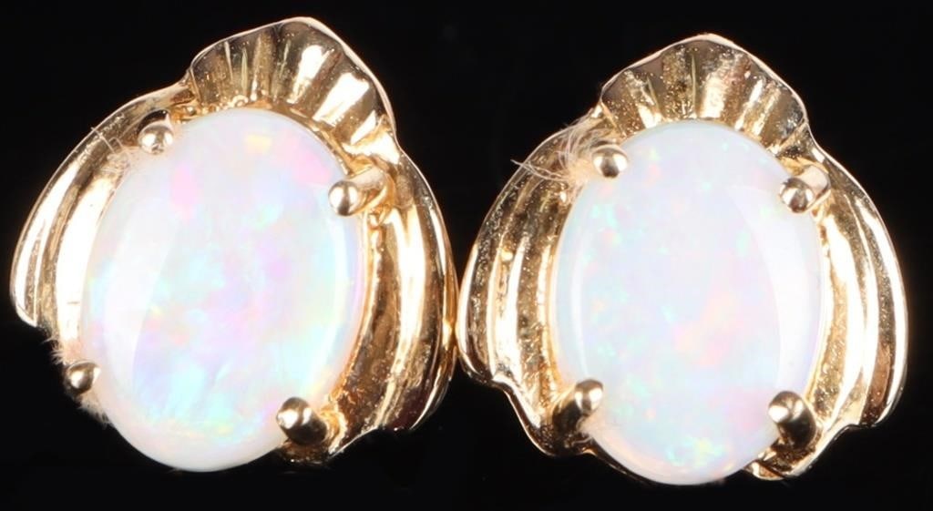 14K YELLOW GOLD OPAL LADIES SEASHELL EARRINGS: 14K yellow gold opal ladies seashell earrings. Gemstones to include one 8.14mm X 6.16mm cabochon opal per each earring. Stone Type: Opal Weight: 1.90 Grams Size: 0.375" Condition: Little to no wear, s