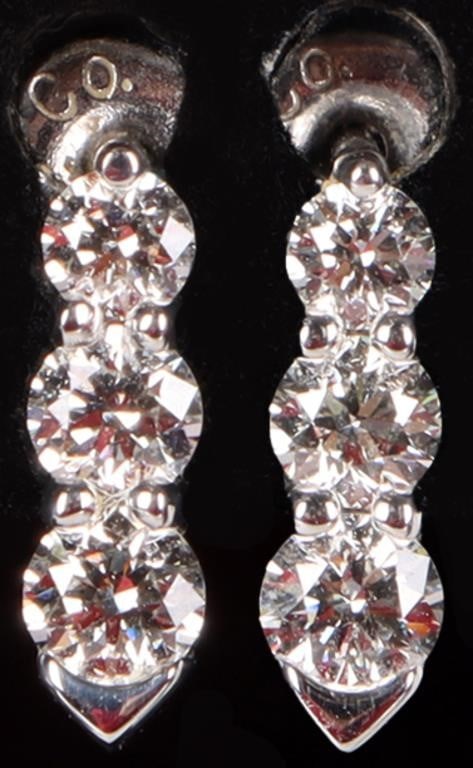 18K WHITE GOLD LADIES STUD EARRINGS W/ DIAMONDS: Pair of 18k white gold ladies stud earrings with three round-cut diamonds arranged in a tapering row each (one 0.1ct piece, one 0.07ct piece, and one 0.05ct piece). Stone Type: Diamond Weight: 1.84 gr