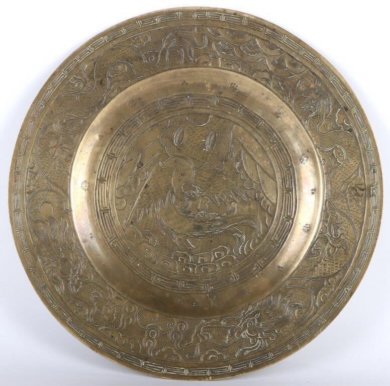 ANTIQUE CHINESE LARGE BRASS DRAGON CHARGER PLATE: Antique Chinese large brass dragon charger plate. The detail on the charger plate is very detailed. There is a stamp on the underside of the plate possibly the artists name. Size: 12" diameter Co