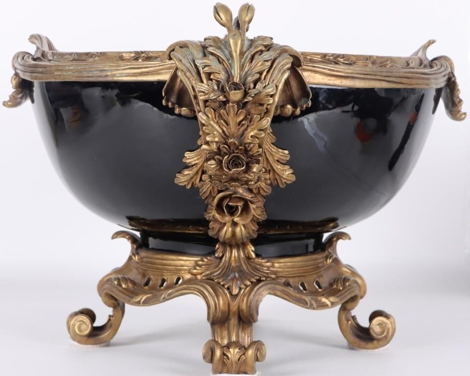 CASTILIAN IMPORTS EMPIRE STYLE CENTERPIECE BOWL: Castilian Imports French Empire style centerpiece bowl composed of black porcelain and cast ormolu brass. Circa 1980's. 31.3 lbs. Size: 22 x 15 x 12" Condition: Corrosion on brass, see pictures for mo